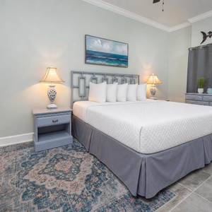 Sink into the plush king bed in the master suite and rest among soft pillows, and enjoy the coastal artwork