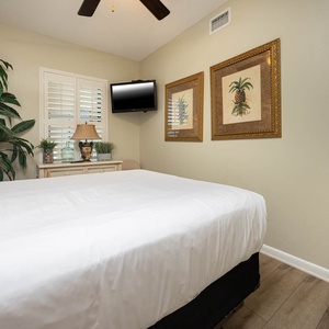 inviting guest bedroom featuring a queen bed, a TV, and decorative accents for a restful stay