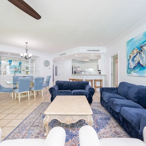 Enjoy leisurely conversations in the spacious living area, surrounded by coastal decor and natural light