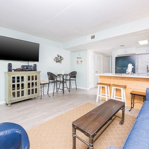 This inviting space features a cozy seating area with a view of the stylish kitchen and a welcoming atmosphere for relaxation