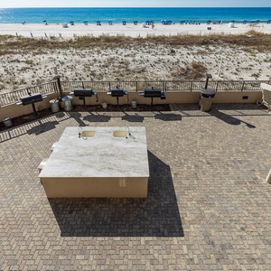 Grill and gather around the spacious outdoor area, enjoying easy access to the beach just steps away