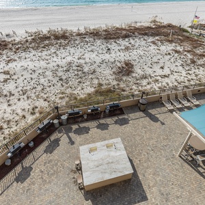 Gather around the outdoor grilling area with ample seating, perfect for enjoying meals and the coastal atmosphere