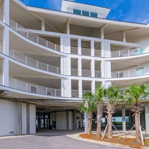 Relax on the sandy beach just steps from your rental, with vibrant umbrellas and stunning views for a perfect getaway