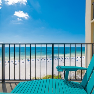 Relax on the turquoise chairs of your private balcony, overlooking the inviting pristine white sand and vibrant blue waters