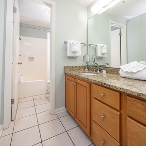 Enjoy the master bathroom featuring a granite countertop, ample storage, and a relaxing tub-shower combination