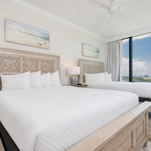 Experience restful nights in this inviting guest room with two queens, coastal decor, and stunning views