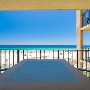 Blue skies stretch over the shore while you relax on your balcony enjoying the warm breeze and distant sounds