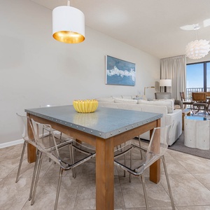 Gather around the sleek dining table, enjoying the airy space and views through large windows