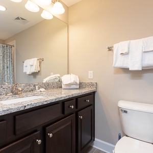 Freshen up in this guest bath in the relaxing shower or soothing tub before an exciting beach day