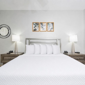 Relax on the cozy queen bed in this guest suite and enjoy a peaceful slumber