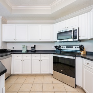 Prepare meals in this kitchen with elegant cabinetry, stainless appliances, and spacious countertops