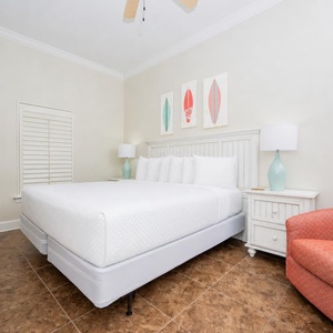 Enjoy restful nights in this inviting guest bedroom featuring a king bed, a cozy chair, and cheerful surf decor