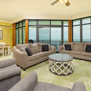 Soft couches and armchairs surround a coastal detail rug perfect for relaxed family conversations in the living room