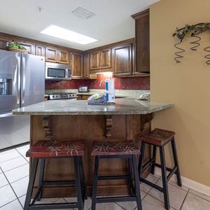 Gather around the stylish kitchen bar area, perfect for casual meals and enjoying drinks together