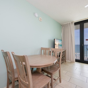 The dining area invites you to enjoy meals while watching waves shimmer beyond your balcony door