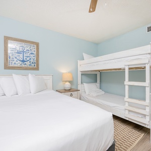 Cozy guest bedroom featuring a double bed and a charming twin bunk bed, perfect for family getaways or friends' retreats