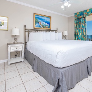Rest peacefully in this master bedroom, featuring a comfortable king bed and beachfront balcony access