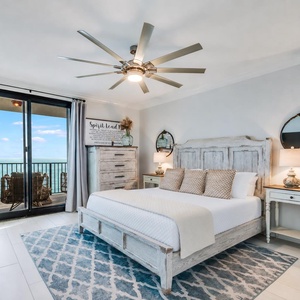 Unwind in this serene master bedroom featuring a comfortable king bed, stylish decor, and beachfront balcony access