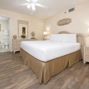 Rest in the guest bedroom featuring a king bed, soft linens, and charming coastal decor for a relaxing stay