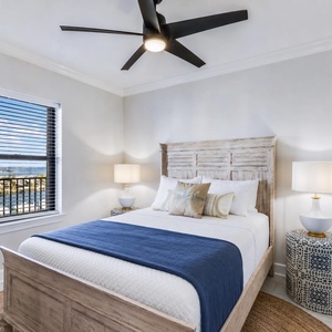 Relax in this guest bedroom featuring a comfortable queen bed, stylish decor, and a view that enhances your stay