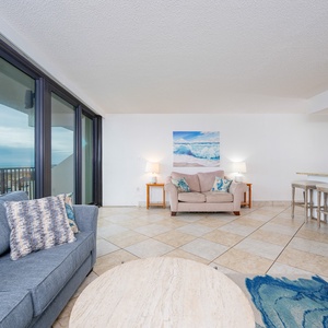 Relax on the plush sofas while enjoying the inviting vibe and breathtaking coast view through the expansive windows