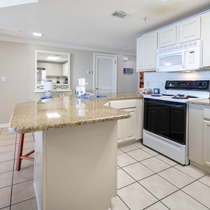 Cook and gather in this spacious kitchen with a large counter, sleek appliances, and a welcoming layout for shared meals
