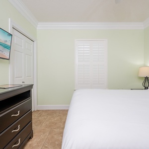 Unwind in this guest bedroom featuring a queen bed, soft linens, and a TV for your entertainment