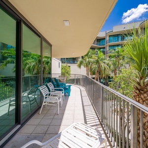 Breathe in fresh coastal air as you lounge on the balcony, surrounded by lush palm trees and tranquil views