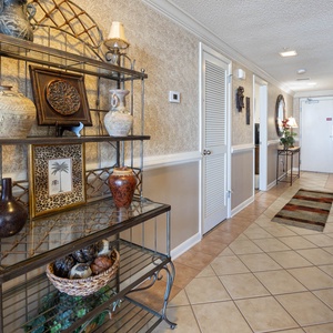 Step into this welcoming hallway adorned with decorative accents and a cozy seating area for your comfort