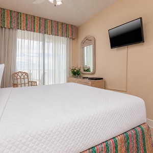 Relax in this inviting master suite with a king bed, a TV, and access to stunning views from the balcony