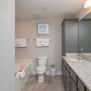 Refresh in the master bath after a day at the beach with a soothing tub and relaxing walk-in shower