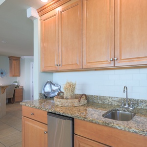 Prepare refreshing drinks at the stylish wet bar, enjoying the coastal vibe as you relax with family