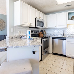 Cook and gather at the granite-topped kitchen, stainless appliances, and sleek design with subway tile backsplash