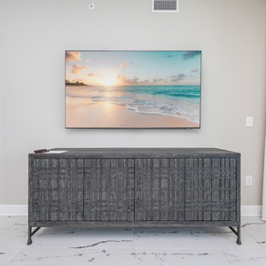 Stream your favorite shows or relax with some music after a fun day at the beach in this relaxing living space