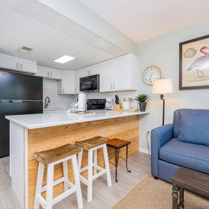 This inviting kitchen features modern appliances and a cozy seating area, perfect for enjoying meals together