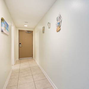 Step into a welcoming hallway adorned with cheerful decor, leading you to your relaxing vacation retreat