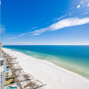 Embrace the coastal vibe from your balcony, soaking in breathtaking beach views and vibrant blue skies