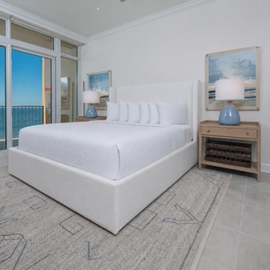 Retreat to the king master suite with cozy bedding and drift off to the sound of the waves from the balcony