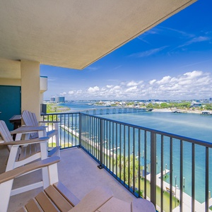 Enjoy a relaxing view of the river from this balcony with comfortable seating, perfect for unwinding after a day of adventure
