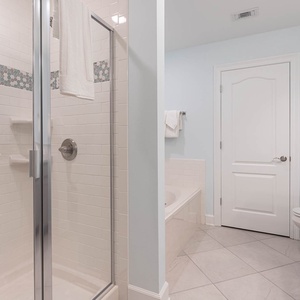 Indulge in relaxation in the master bath with a refreshing walk-in shower, elegant tile accents, and soothing tub