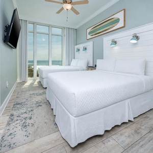 Wake to a breathtaking sunrise in this queen guest suite with two cozy beds and expansive views from the windows