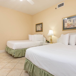 Rest in this comfortable guest room with two double beds, soft linens, and cozy decor
