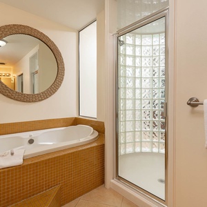 Indulge in relaxation in the master bath with a refreshing walk-in shower and soothing jetted tub