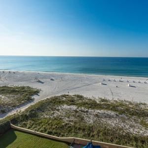 Enjoy panoramic views of the tranquil beach, with soft white sand and gentle waves stretching into the horizon