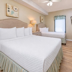 Two plush double beds in the guest suite offer restful spots to unwind while your favorite shows play softly on TV