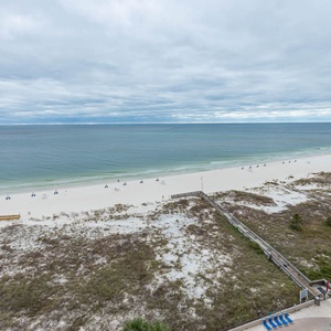 Gaze at the serene waters and soft shoreline, perfect for relaxation and enjoying the coastal atmosphere