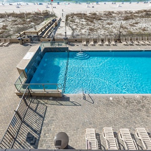 Enjoy the refreshing pool surrounded by lounge chairs, perfect for relaxing under the sun