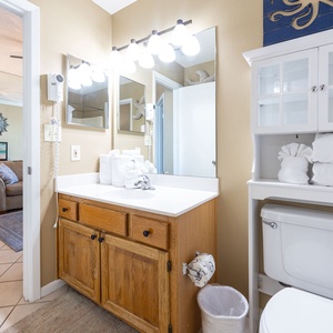 Bathroom featuring a spacious vanity, ample towels, and access from the living space and bedroom