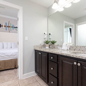 Step into the guest bathroom featuring a stylish vanity, ample counter space, and a relaxing vibe