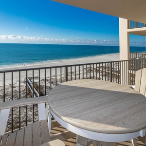 Savor meals on the balcony while enjoying expansive views of the tranquil waters and beach below